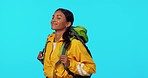 Smelling, happy and a woman hiking for fresh air isolated on a blue background in a studio. Smile, travel and a girl with freedom for camping, trekking and backpacking with mockup on a backdrop