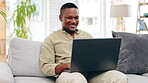 Laptop, sofa and happy black man typing in living room, working or social media in house. Freelancer, remote worker and person with computer on couch writing email, web research or browsing online.