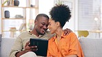 Tablet, couple and smile on sofa in home living room, bonding and online shopping. Interracial, technology and happy black man and woman in love on social media, internet browsing or web scrolling.