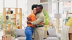 New home, boxes and couple hug in living room, bonding and celebrate moving into apartment together. Real estate, property and happiness of interracial woman and black man embrace for house mortgage.