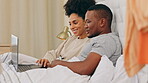 Laptop, couple and relax in bed in home, bonding and talking together in bedroom. Interracial, computer and happy black man and woman on social media, online browsing or web scrolling while speaking.