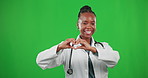 Woman, doctor and green screen for heart sign and smile as support and care. Happy black female or healthcare portrait with hand sign, icon or emoji for love, charity or health insurance and wellness