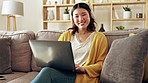 Laptop, sofa and Asian woman relax with headphones for watching movies, videos and streaming music. Remote work, home and happy girl in living room on computer for entertainment, film and audio