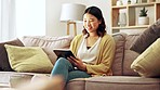 Happy woman, tablet and home on social media, reading ebook and online website application. Asian female, digital technology and connection in house for networking, search internet and download games