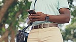 Closeup, hands and black man with smartphone, typing and connection for social media, chatting and sms. Zoom, hand and male with cellphone, mobile application and texting with signal and travelling