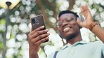 Hello, video call or black man in a park walking, talking or speaking in communication with a happy smile. Blurry, wave or African businessman networking in conversation on commute via mobile app