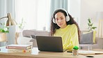 Woman, headphones and living room in a home with a female student listening to music. Remote work, desk and young person dance in a house feeling calm with a smile and hearing internet radio