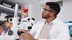 Science, research and man checking fluid, science and experiment in laboratory, medical and results. Male employee, researcher and chemist with red liquid, testing or chemistry with assessment in lab