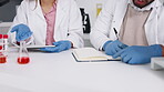 Closeup, hands and research with planning, writing and innovation for diagnosis, experiment and discussion in laboratory. Zoom, blue gloves and researchers with ideas, making notes or science formula