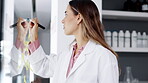 Scientist in laboratory, woman brainstorming and writing on glass board for science, medical research and tablet. Planning, female in lab for scientific study with digital device and sticky note