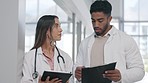 Medical, researchers and employees share notes, planning and schedule for surgery. Man, woman and doctors compare results, conversation or information for healthcare, research or solution in hospital