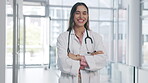 Doctor, woman and arms crossed, face and smile with confidence and pride, healthcare and surgeon in hospital. Happy female physician, portrait and medical professional with success in medicine