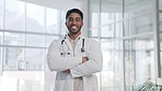 Doctor, man and arms crossed, face and smile with confidence and pride, healthcare and surgeon in hospital. Happy male physician, health and medical professional with expert in medicine in portrait