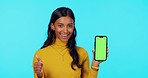 Happy woman, phone and mockup on green screen with thumbs up and tracking markers against studio background. Portrait of female showing thumb emoji, yes or like on smartphone display for advertising