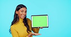 Happy woman, tablet and mockup on green screen with tracking markers against a blue studio background. Portrait of female showing touchscreen display for product placement, advertising or marketing