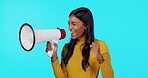 Happy, megaphone and shouting with Indian woman in studio for announcement, good news and vote. Change, speech and promotion with female on blue background for attention, ambassador and opinion