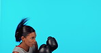 Fitness, mockup or sports woman boxing in training, exercise or workout in studio on blue background. Wellness, motivation or girl boxer with speed, fast or powerful punch or strong warrior mindset