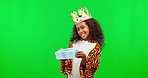 Face, green screen and girl in a costume with a present, happiness and excited against a studio background. Portrait, female child and young person with gift, excitement and cheerful with package