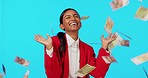 Business woman, cash shower and studio with celebration, surprise and winning by blue background. Indian businesswoman, money rain and happiness for profit, bonus and financial success by backdrop
