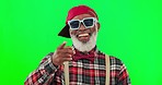 Fashion, happy and man in studio with green screen with point hand gesture and positive mindset. Confident, smile and senior African model with sunglasses and stylish outfit by chroma key background.