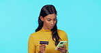 Woman, phone and credit card on mockup for online shopping, ecommerce or purchase against a blue studio background. Female shopper buying on smartphone for electronic transaction or internet banking
