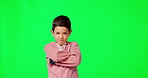 Face, green screen and boy with arms crossed, angry and frustrated against studio background. Portrait, male child or kid with anger, grumpy or attitude problem with facial expression and frustration
