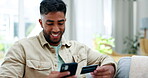 Happy man, phone and credit card on sofa for online shopping, ecommerce or purchase at home. Male shopper relaxing with smile on living room couch on smartphone for electronic transaction or banking