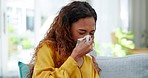 Sick, nose blow and woman at home with illness on a living room sofa with a tissue. Virus, allergy and tired feeling with the wellness problem on a lounge couch in a house from disease and covid