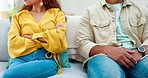 Sofa, argument and sad couple in apartment fighting about marriage crisis, debt and infidelity with conflict. Drama, angry woman and annoyed man in living room with breakup, divorce or life problem.