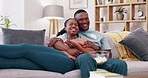 Laughing couple relax to watch movies on tv, comedy and cable show of funny broadcast, sofa and popcorn. Happy man, woman and black people change television remote on streaming, subscription or smile