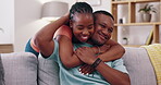 Happy couple, young love and hugging in lounge for care, happiness and quality time together. Man, woman and black people with affection, support and relax in apartment, smile and romantic bonding 