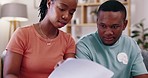 Budget, documents and couple in a living room with paperwork for paying bills, savings and planning. Financial, form and woman with man checking form for home loan, mortgage or investment in a lounge