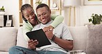 Video, tablet and black couple with hug on a living room couch with happiness and smile. Series streaming, web and home of a woman and man together on a lounge sofa watching a movie on a app