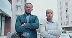 Collaboration, serious and business people in the city, arms crossed on their morning commute to work. Portrait, mindset or professionalism with a black and woman employee team in an urban town