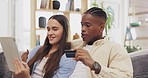 Tablet, couple and credit card for online shopping in home on sofa, payment or digital banking. Interracial, ecommerce and happy black man and woman laugh with tech for fintech, sales app or finance.