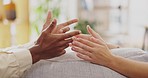 Couple, divorce and hands in argument, sofa and anger of frustrated problems, blame and crisis. Closeup of angry man, woman and partner fighting in toxic relationship, drama and conflict of cheating