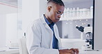 Typing, research and scientist on computer for laboratory data analysis, report update or information with focus. Serious black man or medical worker with science career working on a desktop pc