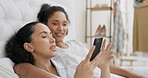 Phone, relax and lgbt couple in bed watching video on social media or online streaming service together. Lesbian women reading email, website or message while bonding in bedroom and browsing internet