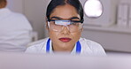 Scientist in laboratory, woman and computer with focus on science study for medical research and scientific innovation. Female working in lab, safety goggles and analysis of test results with biotech