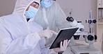 Tablet, medical research and people in a lab, hazmat and discussion for experiment, planning or update results. Scientists, researchers or employees with a device, technology or healthcare innovation