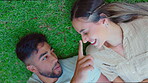 Top view, happy couple and touch nose at park, grass and nature of love, care or support of quality time together. Young man, woman and relax on lawn for fun, freedom or outdoor date in summer garden