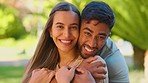 Park, love and face of interracial couple hug for bonding, quality time and relax on bench for weekend date. Nature, dating and portrait of happy man and woman for embrace, commitment and romance