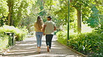 Happiness, park and couple running in a forest rail together on a date in nature and bonding outdoors. People, man and woman playing enjoying freedom and romance in the green woods in summer