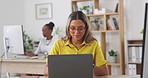 Laptop, typing and female working in the office doing research for a creative marketing project. Happiness, smile and professional female employee planning company report on computer in workplace.