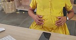 Massage belly, sitting and a pregnant woman in the office, touching stomach and break from work. Love, relax and an employee feeling her tummy during pregnancy at the workplace for relaxation