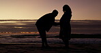 Silhouette, beach and pregnant couple with man rubbing expecting woman stomach or belly at sea or ocean. Baby, pregnancy and shadow of a woman on vacation or holiday with husband during maternity