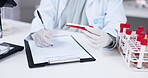 Hands writing, clipboard and blood test tube for research in laboratory, information and results. Checklist, science and scientist or woman with sample for medical analysis, dna testing and notes.