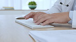 Doctor, keyboard and typing with hands of man and typing for healthcare, research and website. Technology, communication and medical with employee at computer for report, online and medicine analysis