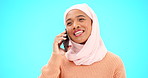 Phone call, talking and communication with muslim woman in studio for networking, contact and conversation. Connection, technology and chatting with female on blue background for discussion and news