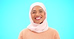 Muslim woman, happy and laughing portrait with a scarf for mockup, advertising or joke. Islamic female model with laugh, makeup and hijab for peace, funny thought and fashion on blue background 